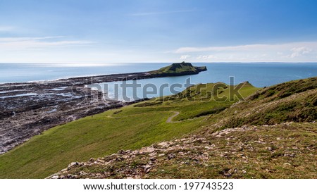 Views across Rhossili Bay to the Worms Head Headland, Wales UK Europe UK Europe