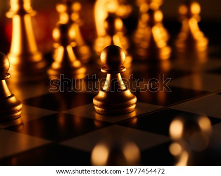pieces on chessboard against dark background