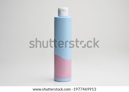 Cosmetic cream , serum, skincare blank bottle packaging with leaves herb, bio organic product. Cosmetics mockup for branding. Beauty makeup product. Blu pink plastic cosmetics container for shampoo. 