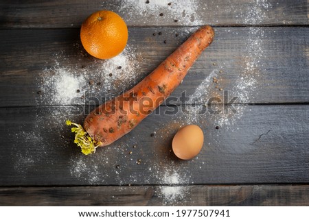 Flat lay picture with carrot egg and orange