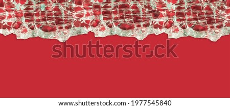 Magnified image of a cracked glass on a red background