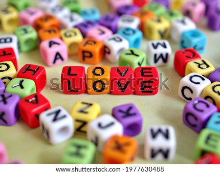 Education alphabet beads letters on white background ,love words for background or letter blocks wallpaper ,valentine's day ,colorful plastic beads .visual matches ,educational
