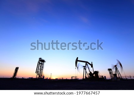 In the evening, the silhouette of the oil pump, Beam pumping unit