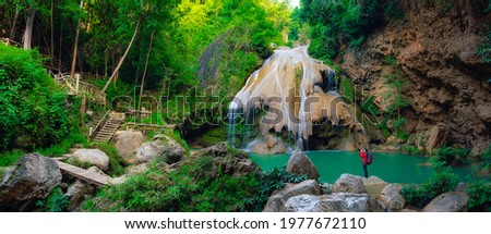 Panorama of Ko luang waterfall turquoise blue river with tourists taking pictures at the waterfalls in Mae Ping National Park, Lamphun, Thailand.