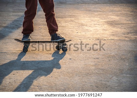 Urban skating - Detail of the feet of a young man on a skateboard