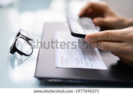 Taking Remote Deposit Payroll Cheque Document Picture Royalty-Free Stock Photo #1977696371