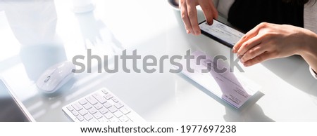 Remote Payroll Cheque Deposit Taking Picture Using Phone Royalty-Free Stock Photo #1977697238