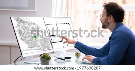Developer Looking At Land Plot Map And Cadastre Plan