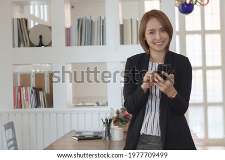 Portrait of businesswoman use smartphone while  in the office.