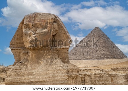 The front face and body of the Sphinx and the biggest Great Pyramid of Khafre appear side by side in the desert of Giza, Cairo, Egypt. Horizontal Copy Space. The Sphinx in Giza pyramid. blue sky