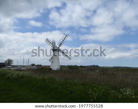 White mill in Thurne next to the river in Norfolk 
