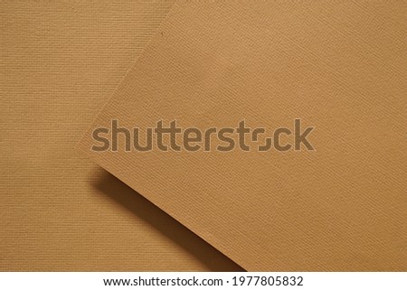 surface of craft brown paper placed on brown paper with hard shadow for background.