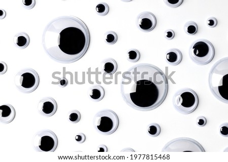 Top view of many shaky plastic doll eyes on white background. Royalty-Free Stock Photo #1977815468