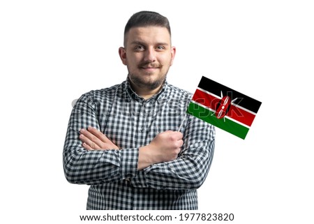 White guy holding a flag of Kenya smiling confident with crossed arms isolated on a white background.