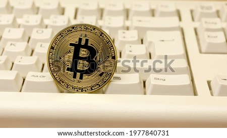 Bitcoin coin on a PC keyboard