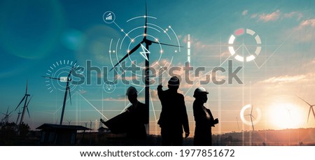Engineering team Wind turbine and Solar power technology alternative eco environment friendly sustainable renewable energy resource concept, solar panel cell photovoltaic plant sunset background. Royalty-Free Stock Photo #1977851672