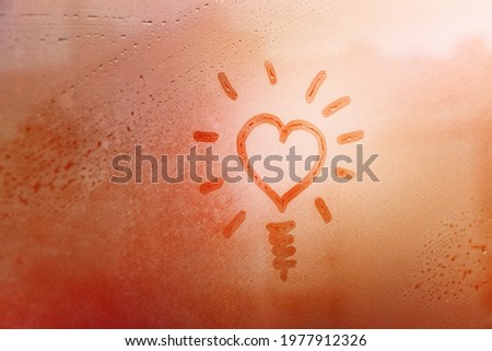 speech buble heart like sun and lamp on foggy window spattered with drops city, yellow red color, copyspace