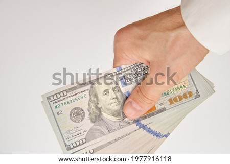 investment 100 dollar bill in a man's hand