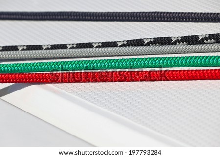 Details of sailing boat. Color ropes on white deck background