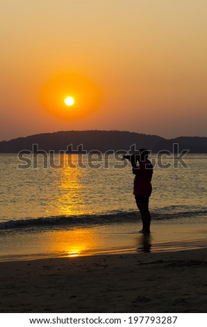 a man take a photo in the sunset moment