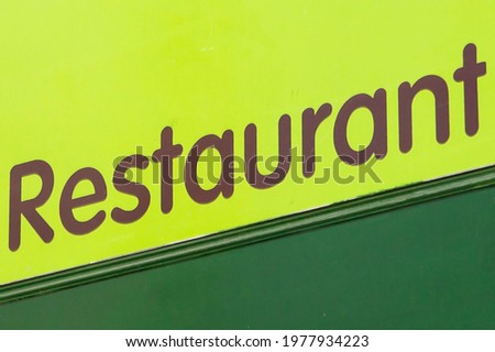 Restaurant sign in dark and light green