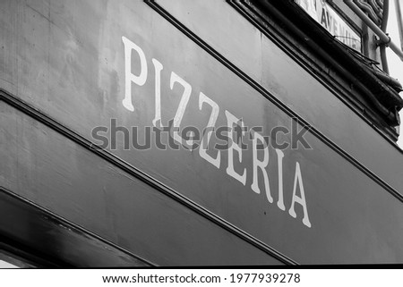 Pizzeria restaurant sign in black and white