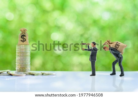 Debt restructuring and debt cancellation, financial concept : Creditor uses a monoscope see and point the way for a debt slave to go forward direction, indebted party has a debt default and npl crisis Royalty-Free Stock Photo #1977946508