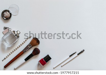 Flat lay view of makeup cosmetic products on white background. Copy space