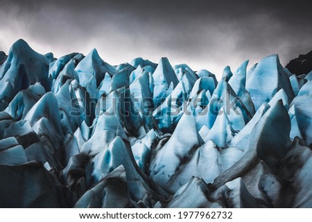 Closeup of the jagged edges that showcase the gorgeous blue details of a glacier. Royalty-Free Stock Photo #1977962732