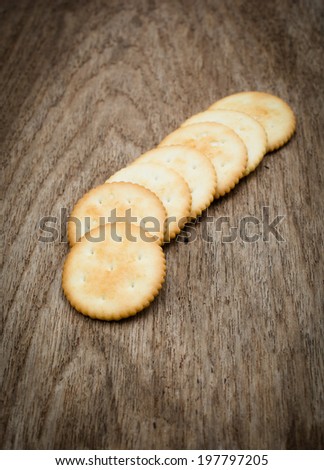 Round cracker on wooden background