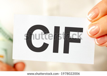 On the table are bills, a bundle of dollars and a sign on which it is written - CIF. CIF short for Custom Factory Integration. Can be used for business, finance and economics concept.