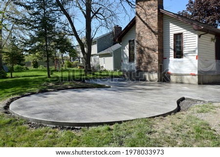 Backyard Patio Construction with a Concrete Cement Foundation by Builders for a Stamped Patterned Surface