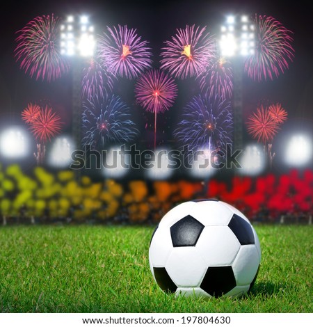 Football on the field with stadium and firework background