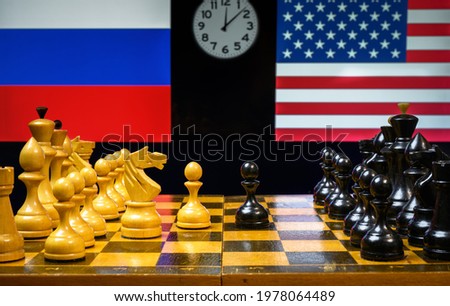 Russia vs USA, Putin and Biden play  geopolitics game like chess. United States and Russian flags behind chessboard. Concept of political tension, summit, economy war, sanctions and world leadership. Royalty-Free Stock Photo #1978064489