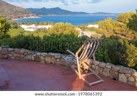 Sardinia bay outlook with chair from patio