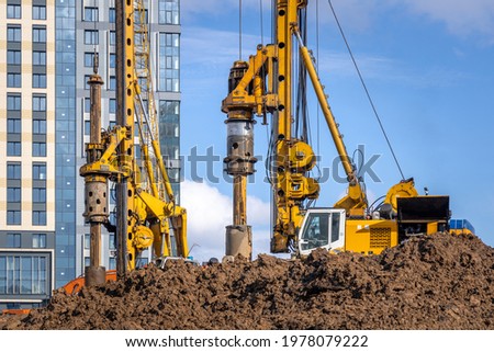 BAUER BG 36 rotary drilling rigs at the Plaza Botanica skyscraper construction site. Construction of bored piles for the building foundation. Russia, Moscow - May 3, 2021 Royalty-Free Stock Photo #1978079222
