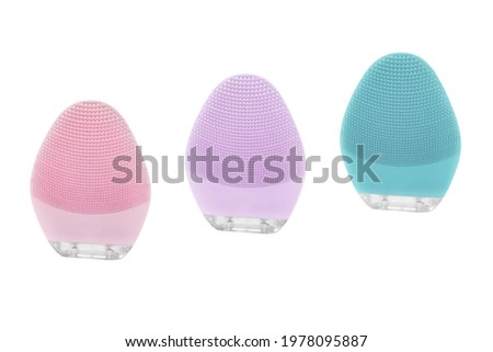 Silicone electric smart brush for cleansing face and pores in pink, purple and turquoise colors isolated on white background