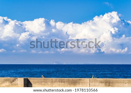 Dramatic Landscape of Cumulonimbus or Thunderous Clouds above The Sea or Ocean in Summer, Stormy Cloud, Seto Inland Sea in Kagawa Prefecture in Japan,  Natural Image, Nobody Royalty-Free Stock Photo #1978110566