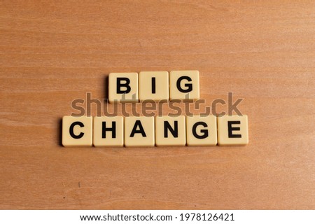 Top view of alphabet letters with text BIG CHANGE on wooden background