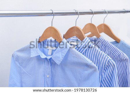long sleeved blue and two striped shirts ,blue sweater on hanger