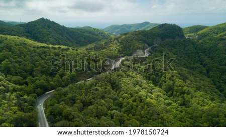 Mountain winding zig zag road. Top aerial view: cars driving on road from above. Royalty-Free Stock Photo #1978150724