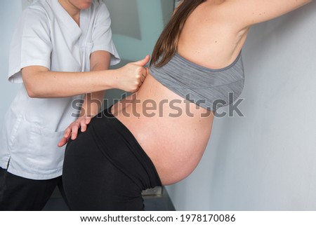 pregnant woman receiving treatment in clinic Royalty-Free Stock Photo #1978170086