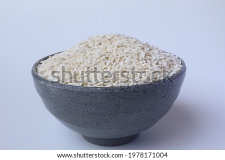 A pile of glutinous rice inside grey bowl, isolated on white background
