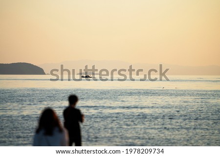 People at sunset on the beach in Shikoku.