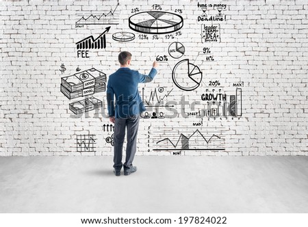 businessman drawing business plan, graph, chart on wall