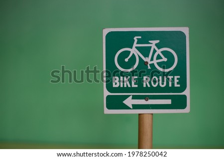 Green road sign, bike route sign isolated on green background. 