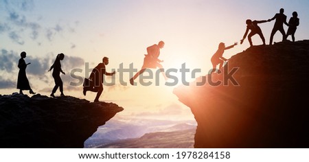 Challenge of business concept. Group of businesspeople climbing a mountain. Teamwork. Success. Royalty-Free Stock Photo #1978284158