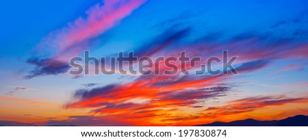 Bright colorful sunset on the sea with beautiful clouds. Panoramic.