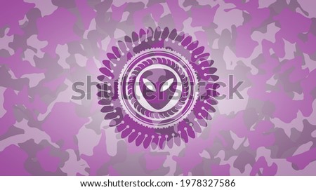 alien icon inside pink camouflaged emblem. 