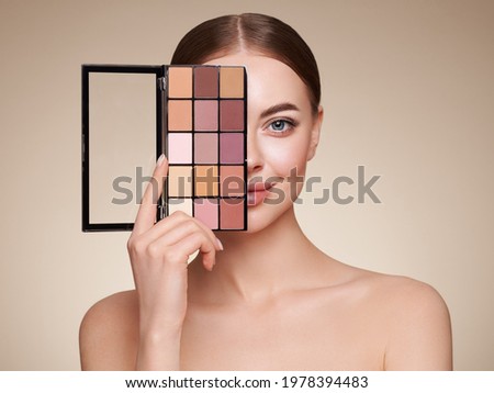 Beauty woman with eye shadow makeup palette. Model with healthy perfect skin, close up portrait. Cosmetology, beauty and spa Royalty-Free Stock Photo #1978394483